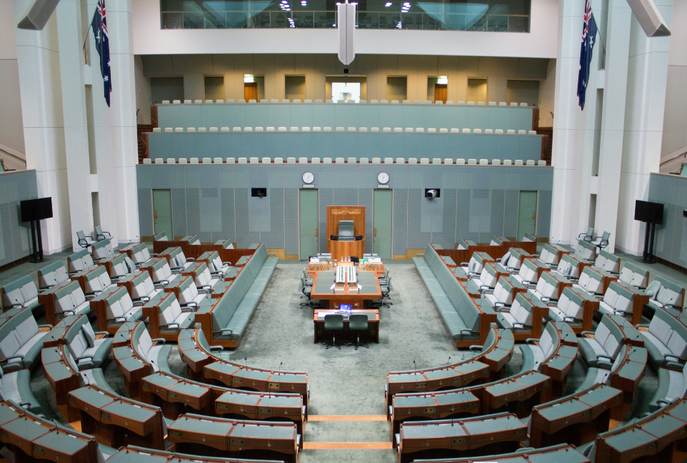 a large room with rows of chairs and a podium